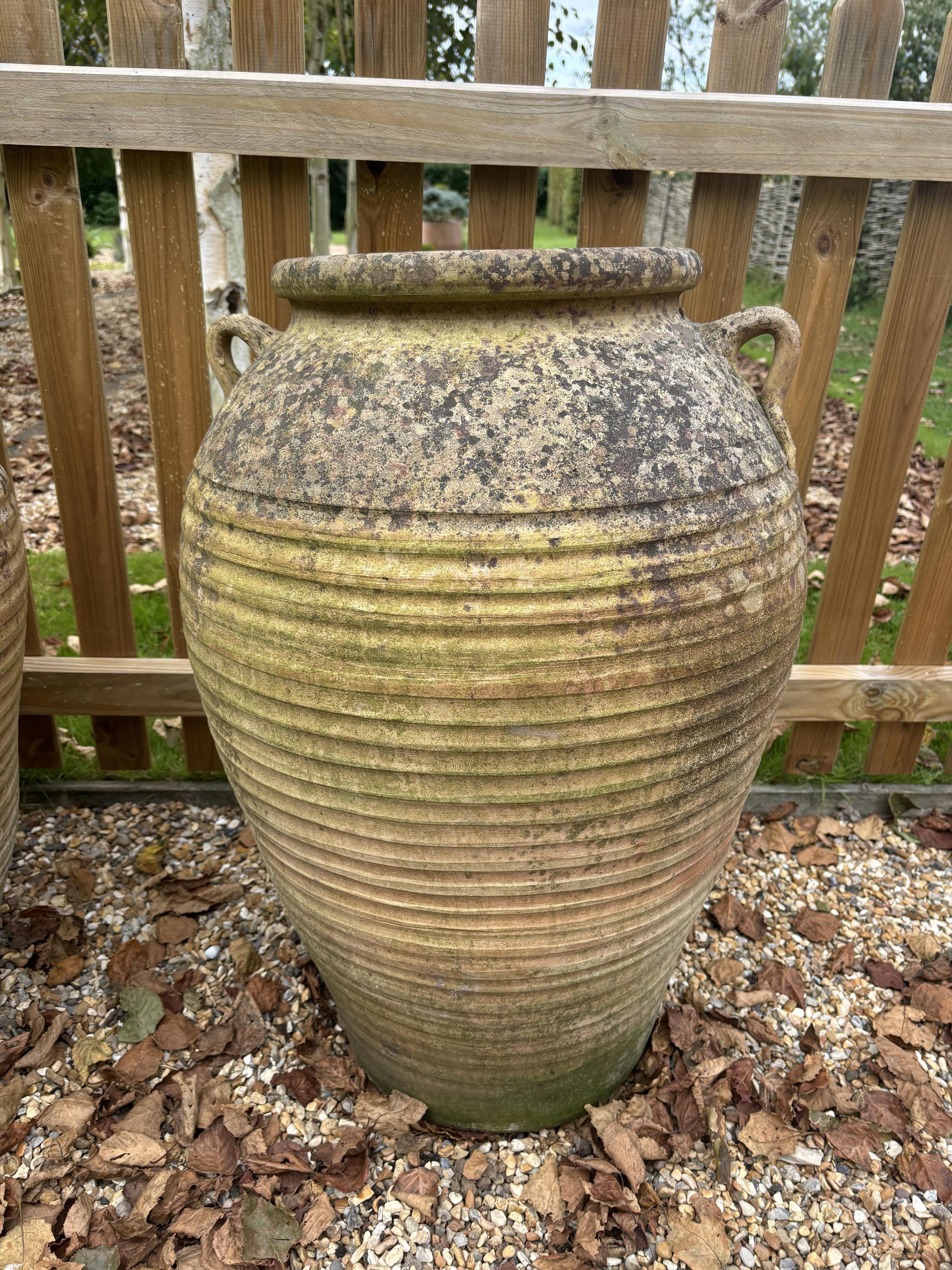 A pair of Italian style terracotta urns, height 75cm, width 48cm. Condition - weathered, otherwise good